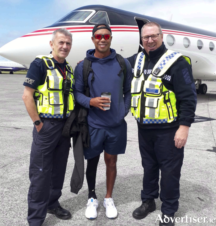 On hand to meet the golfers as they used the Shannon Airport corporate jet services provided by the airport’s fixed base operators were, Shannon Airport Police Fire Service staff Declan Lynch and Eugene Fawl who are pictured here with Tiger Woods.
