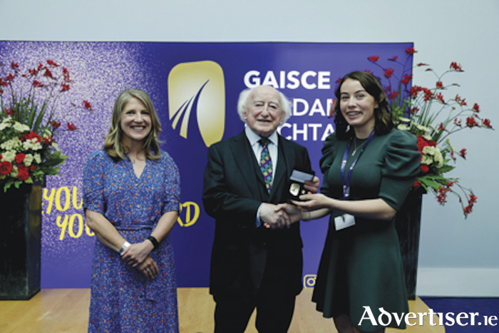 Athlone native, Sinéad Reidy is pictured with President of Ireland, Michael D. Higgins, and Yvonne McKenna, CEO of Gaisce, upon receipt of her deserve Gold Medal award
