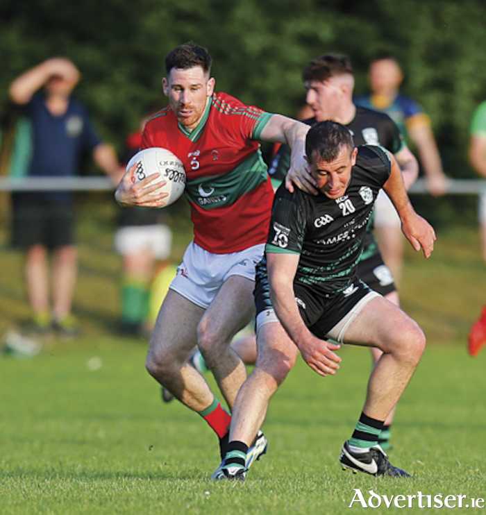 James Dolan holds off a challenge from Michael Curley as Garrycastle got their Westmeath senior football championship campaign off to a winning start against Mullingar Shamrocks in Ballymore on Friday evening last.  Photograph by AC Sports Images.
