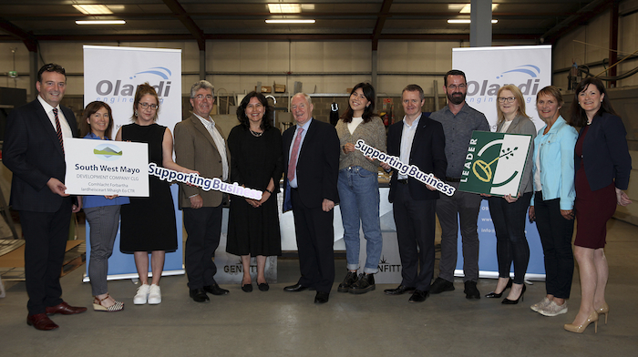 Deputy Michael Ring TD, together with Olandi Engineering MD and family, members and staff of Mayo County Council and Mayo Local Action Group (LAG), Head of Enterprise LEO Mayo, and South West Mayo Development Company Board Member, CEO and staff at the €150,000 LEADER cheque presentation towards a state-of-the-art laser CNC machine for Olandi Engineering. L-R: Cllr Cyril Burke, Majella Mulchrone (Finance Team, SWMDC), Maura Murphy (Mayo County Council ), Damien Flynn (MD, Olandi Engineering), Janine Flynn (Director, Olandi Engineering), Michael Ring TD, Tahnee Flynn (Olandi Engineering), John Magee (Head of Enterprise LEO Mayo & Mayo LAG member), Seán Carolan (LEADER Manager, SWMDC), Annette Maughan (Moy Valley Resources CEO & Mayo LAG member), Breege Joyce (Board Member, SWMDC) and Sabina Trench (CEO, SWMDC). Photo: Trish Forde.