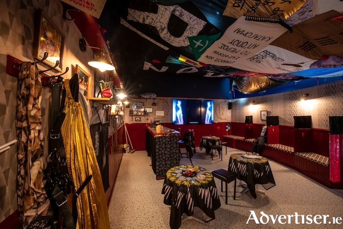 The 2021 Turner Prize winners, the Array Collective, is a group of 11 Belfast-based artists. The centrepiece of the work is The Druthaib’s Ball, a built installation that invites audiences into an immersive experience reflecting the lively community hub of the Irish síbin, a long-established tradition of an illegal bar. Pictured is the interior of the síbín. Photo: Garry Jones Photography. For more see https://www.galwayartscentre.ie