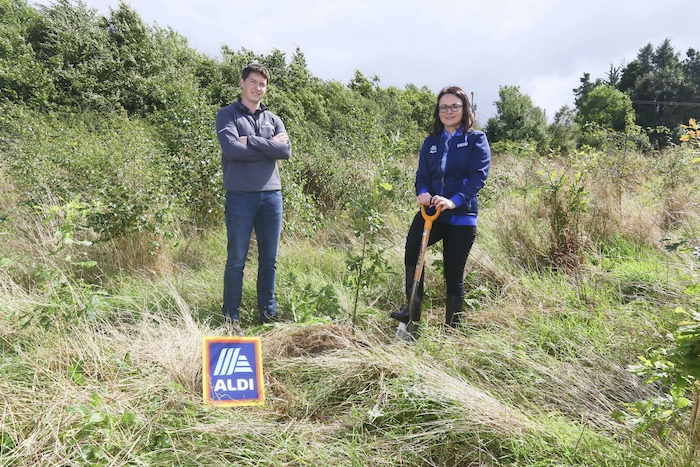 To celebrate the upcoming opening of the new ALDI Ballina store this week, the ALDI Ballina store staff have teamed up with Green Belt and local landowners John and Stella Drummond to plant over 12,000 trees in Coollagagh, Co. Mayo. ALDI is the first retailer in Ireland to commit to planting 1 million native Irish woodland trees by 2025 in partnership with Green Belt. Pictured at the site of the tree planting in Coollagagh is Charlene Kilgallon, ALDI Ballina Store Manager and Ronan Gallagher, Green Belt Forester. 
