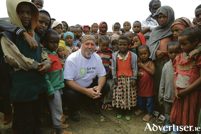 Ronan Scully of the Irish Emergency Alliance and Self Help Africa with some young beneficiaries in need at the Debra Berahan IDP camp in Ethiopia, where more than 20 million people are affected by drought.