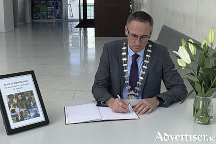 Cllr Aengus O’Rourke, Cathaoirleach, Westmeath County Council, signs the Creeslough tragedy book of condolence which is open to members of the local public until tomorrow, Friday, October 14, at 5pm