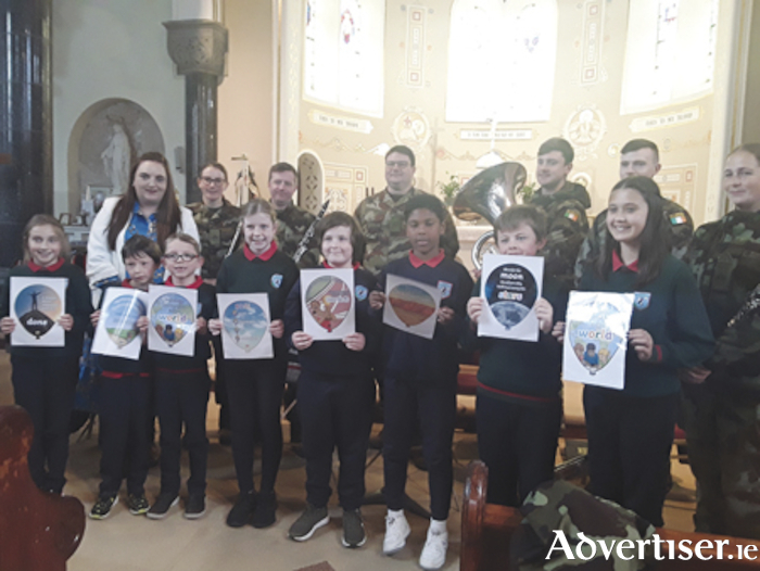 An Grianan National School ‘Wellbeing Warriors’ are pictured with teaching staff member, Dolores Killian and members of the Band 2 Brigade Army Band at the school’s recent Amber Flag initiative launch in Corpus Christi Church, Mount Temple