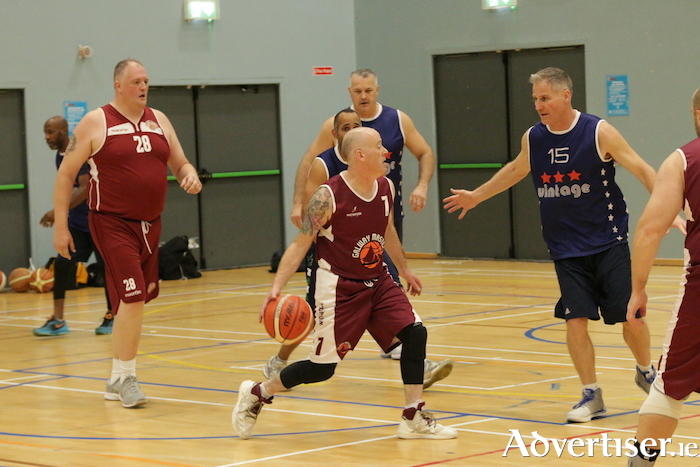 Paul Flanagan brings the ball up the court for Galway watched by Chris Corbett (15) from Vintage USA in the men’s over 40 division.