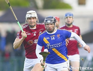 Jamie Ryan of winners Loughrea is chased by Ois&iacute;n Salmon, Clarinbridge, in the Brooks Senior Hurling Championship semi-final at Pearse Stadium on Sunday. Photo:- Mike Shaughnessy