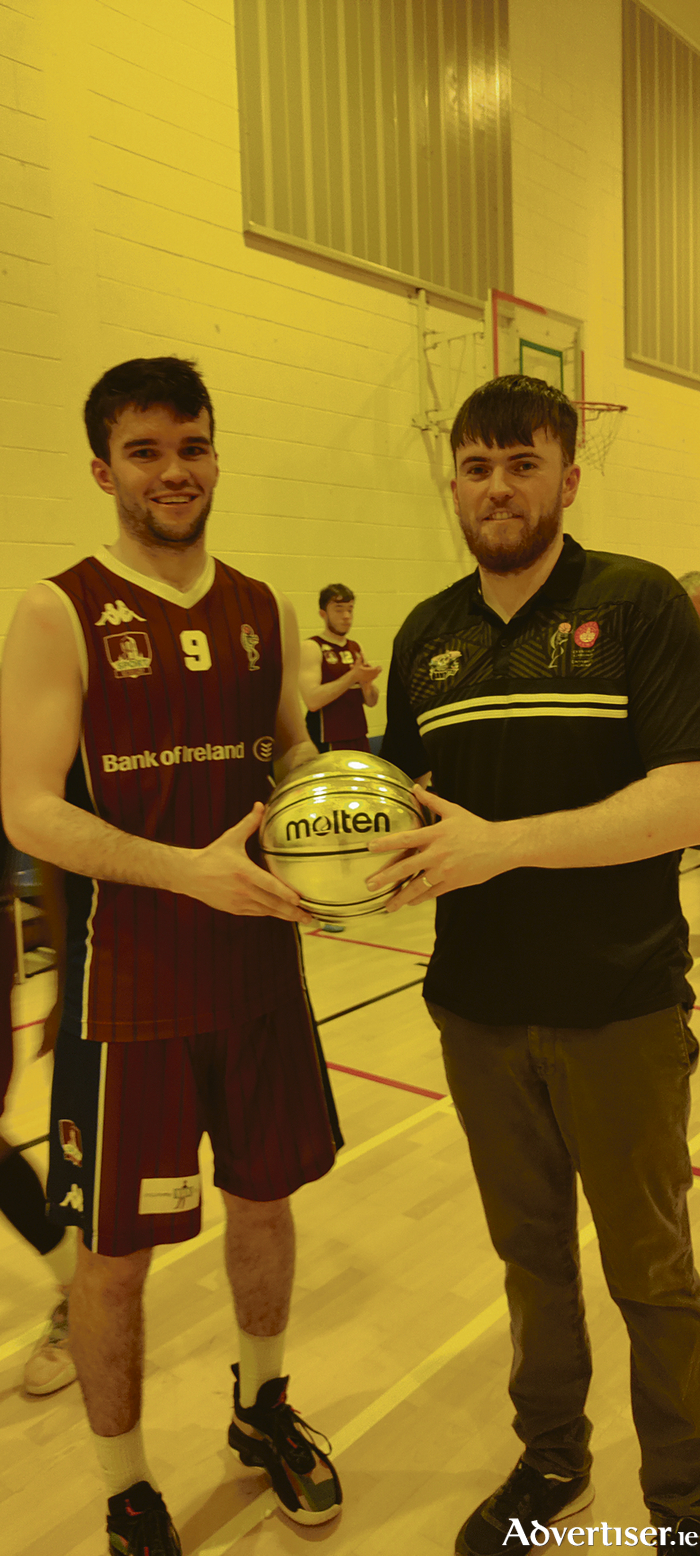 Charlie Crowley, head coach University of Galway Maree, receives his InsureMyVan.ie Superleague Coach of the Month from University of Galway Maree co-captain Eoin Rockall after Saturday's game. 