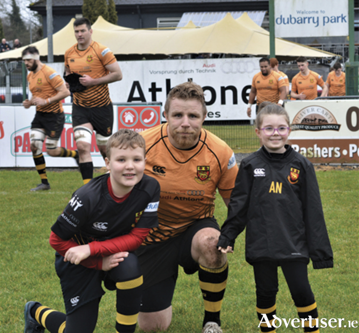 Buccaneers captain, Martin Staunton, is pictured with matchday mascots, Campbell Walkinson and Aoife Nolan, prior to the Pirates victory over St Mary’s College at the weekend
