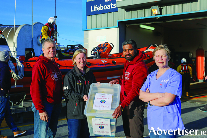 Olivia Byrne, volunteer RNLI crew member, accepting a donation of medical supplies from Mike Smith, Philip Parakal Augusthinose and Prof Dara Byrne from the University of Galway Clinical Simulation and Interprofessional Education Facility, during a recent visit to the Galway Lifeboat Station. From left: Mike Smith, Olivia Byrne, Philip Parakal Augusthinose and Prof Dara Byrne. Photo Martina Regan