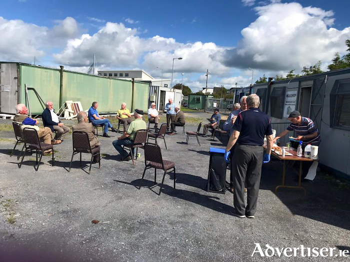 Some of the Oranmore Men's Shed relax outside the old premises during Covid-19 restrictions. 