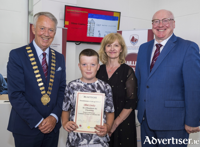 Pictured at the recent prizegiving of the Galway County Council anti-litter competition, from left to right is Cathaoirleach Liam Carroll, winner Oliver Cawley, 5th class, Scoil An Chroí Naofa, Ballinasloe, Director of Services Eileen Ruane, and Chief Executive Liam Conneally.
 