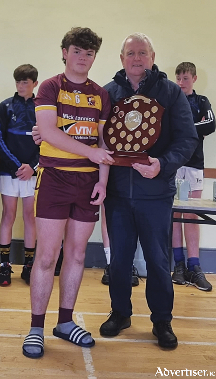 Southern Gaels Under 15 captain Aaron Hardiman is presented with the Ballinamere/Durrow Shield by Brendan Buggy.