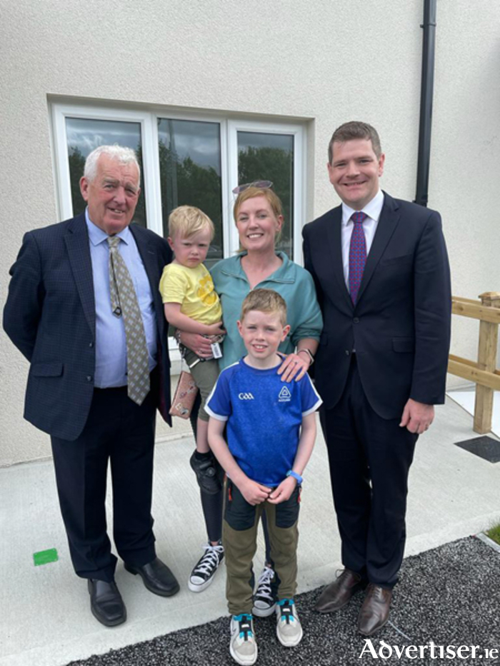 Minister Peter Burke is pictured with Fine Gael Cllr Tom Farrell, Sandra Meacle, Cian and Padraig Murray, prospective tenants in Mount Carmel, Moate
