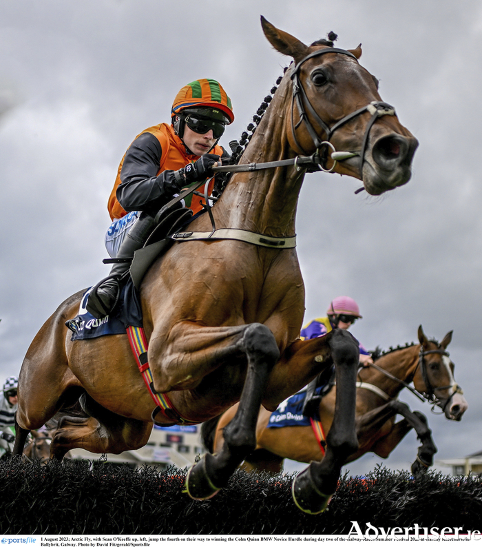 Arctic Fly, with Sean O'Keeffe up, left, jump the fourth on their way to winning the Colm Quinn BMW Novice Hurdle on Tuesday at the Galway Races Summer Festival 2023 at Galway Racecourse. Photo by David Fitzgerald/Sportsfile