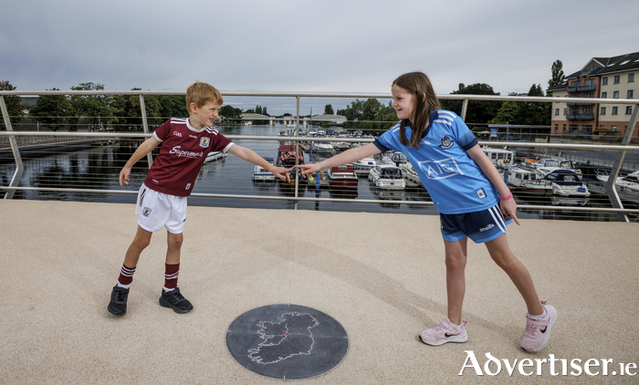 Ronan Mullen (6) from Glenamaddy Co Galway and Anna Kiernan (8) from Glasnevin Co Dublin at the centre point of the bridge pictured at the official opening of the new Athlone Greenway Bridge