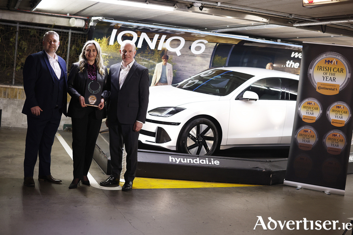 Pictured are Joe Rayfus, Chairman of the MMAI; Sarah Hayes of Hyundai Ireland; Tom Dennigan of awards sponsor, Continental Tyres; with the winning car, the Hyundai IONIQ 6.