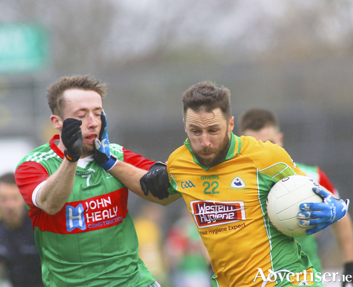 Corofin’s Michael Lundy fights off a challenge from David Tighe, Ballina Stephanites in action from the AIB GAA Connacht Senior Club Football Championship Semi-Final at Pearse Stadium on Saturday. Photo: Mike Shaughnessy 