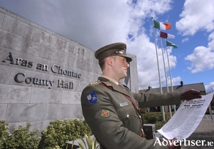 Captain Colin Campbell reads the Proclamation at a flag-raising ceremony at Aras an Chontae on Monday, 25th April 2016, the centenary of the first military action of the 1916 Rising in Galway.