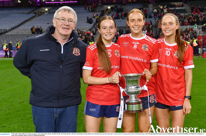 Kilkerrin-Clonberne players, from right, Olivia Divilly, Siobhán Divilly and Niamh Divilly with their dad Michael and the Dolores Tyrrell Memorial Cup after their side’s victory in the Currentaccount.ie LGFA All-Ireland Senior Club Championship final match between Ballymacarby of Waterford and Kilkerrin-Clonberne of Galway at Croke Park