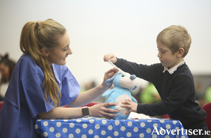 NUI Galway third year Medical student Sinéad Burke with Cian (4) at NUI Galway’s Teddy Bear Hospital today. Photograph by Aengus McMahon.