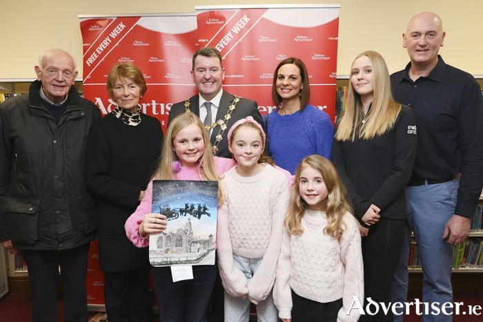 Galway Advertiser Newspaper Christmas Art Competition winner Sadhbh Quilty with her family. Photo: Mike Shaughnessy