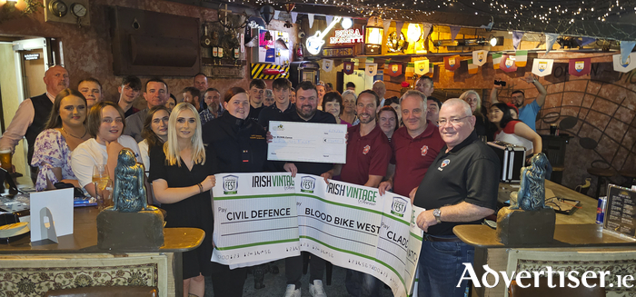 Classic Fest organiser Tom Heavey presents a cheque for €13,695 to Ian Fallon from BUMBLEance.