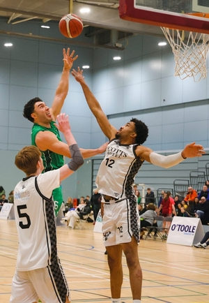 Maigh Cuilinn Basketball Club&rsquo;s Grant Olsson against Eoin Carroll and Mikah Blackwell of Scotts Lakers Killarney in action from the Basketball Ireland Men&rsquo;s Division 1 game at University of Galway Kingfisher Arena on Monday. Olsson scored 24 of Maigh Cuilinn&rsquo;s 65 points who scored 47. Photo: Mike Shaughnessy