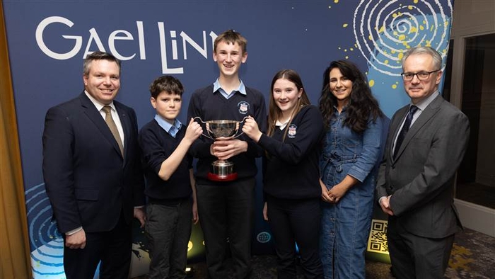 An Teachta Dála Séin Ó Muineacháin agus Réamonn Ó Ciaráin, Príomhfheidhmeannach Ghael Linn, le foireann Choláiste Chroí Mhuire, An Spidéal, Cuán Canny, Diarmaid Mac Réamoinn agus Clíodhna Ní Neachtain agus Príomhoide na scoile,Tríona Uí Mhurchú tar éis a mbua sa rannóg shóisir ag Craobh na hÉireann de Chomórtas Díospóireachta Uí Chadhain Gael Linn 2025.
