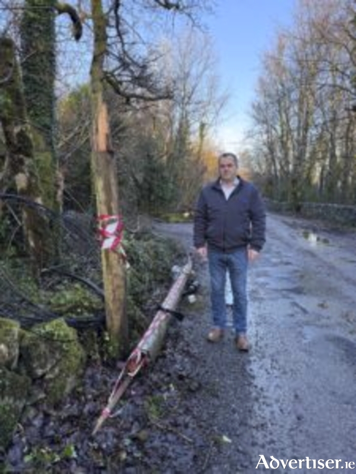 Cllr Noel Thomas at one of the poles in Gortachalla, Maigh Cuilinn — still unrepaired following Storm Eowyn last month.