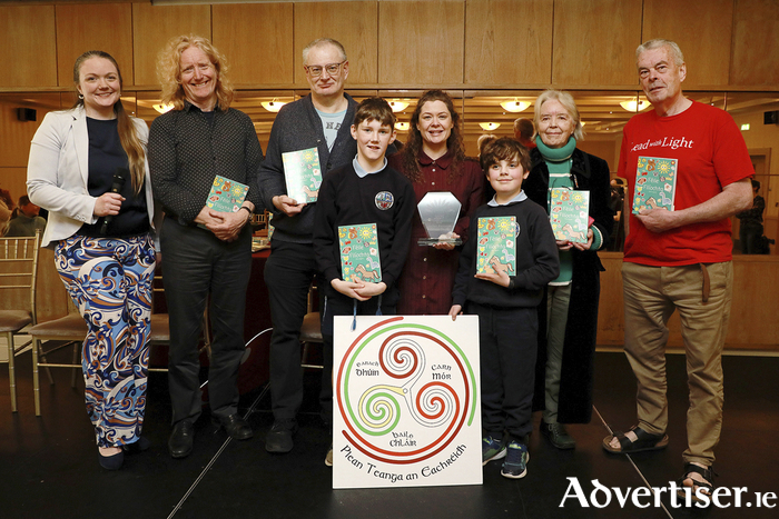 TJ O Mainnin and Max MacCraigh from Scoil Náisiunta Naomh Breandán, Eanach Dhún, were pictured with Barbara NicDhonncha, Louis De Paor, Ciaran Tierney, múinteoir Sarah, and poets Máire Holmes and Seán O Coistealbha at the launch of the 'Féile Filíochta' book at the Claregalway Hotel.