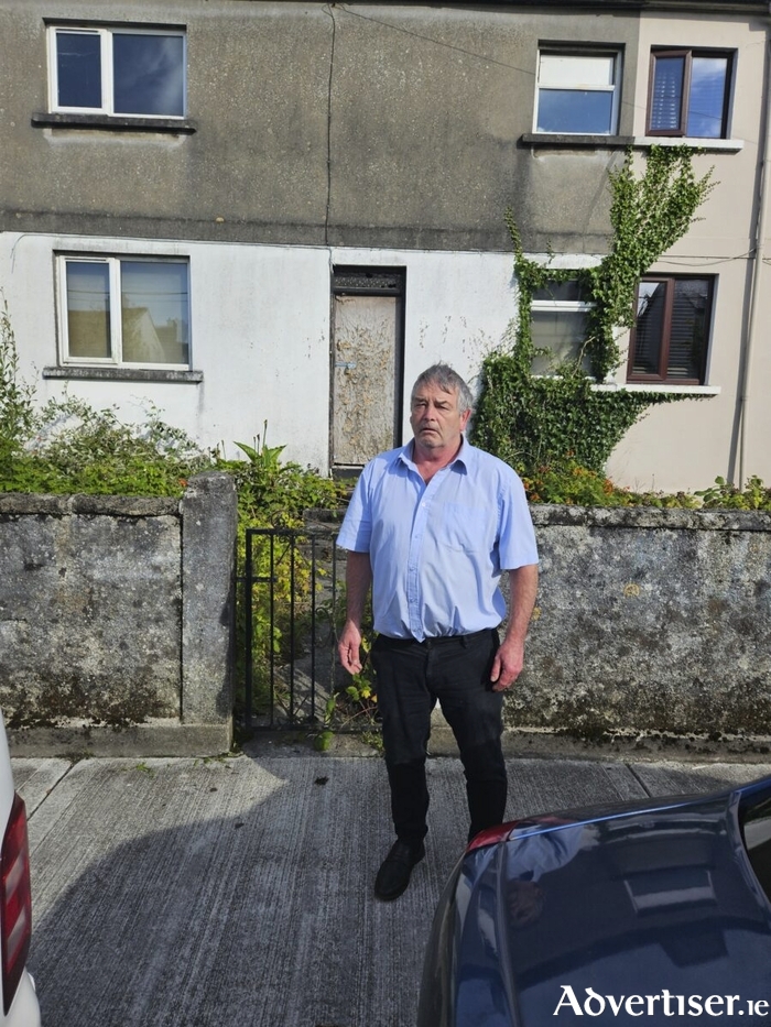 Councillor John McDonagh outside a long-empty council house in the city centre