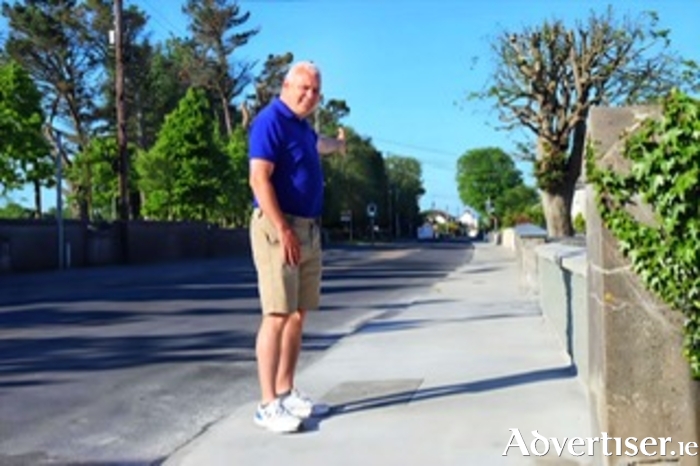 Cllr Shane Forde inspecting resurfaced pavement on the Renmore Road in May