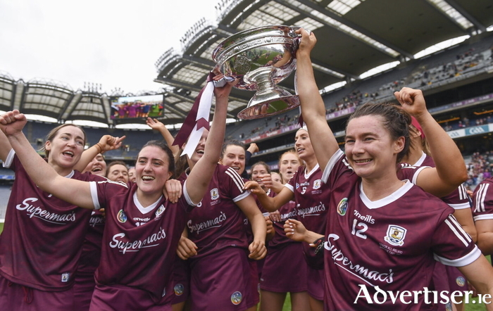 12 September 2021; Galway players Siobhán McGrath, left, and Aoife Donoghue lift The O'Duffy Cup with their team-mates after their victory in the All-Ireland Senior Camogie Championship Final match between Cork and Galway at Croke Park in Dublin. Photo by Ben McShane/Sportsfile