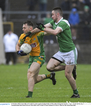  Liam Silke of Corofin in action against Eoghan Kelly of Moycullen during the Galway County Senior Club Football Championship final match between Moycullen and Corofin.