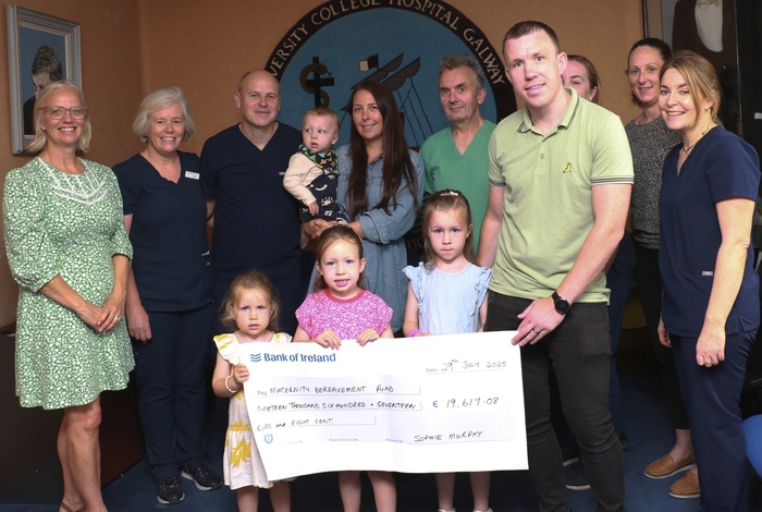 Back row (L to R): Maeve Tonge, Medical Social Worker; Helen Byrnes, Bereavement Support Midwife; Dr Mark Dempsey, Obstetrician; Laura Murphy, Parent with baby Rían; Prof John Morrison, Consultant Obstetrician Gynaecologist and Clinical Director, Women's & Children's MCAN; Louise Fitzpatrick, Assistant Director of Midwifery; Monica Lydon, Clinical Midwife Manager 2, Labour Ward.
Front row: Sophie's dad, Michael Murphy and Sophie's siblings, Holly, Hannah and Ava.