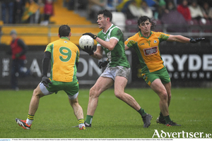 Gerard Davoren of Moycullen in action against Michael Farragher and Kieran Molloy of Corofin during the Galway County Senior Club Football Championship final match between Moycullen and Corofin at Tuam Stadium in Galway. (Photo by Ray Ryan/Sportsfile)