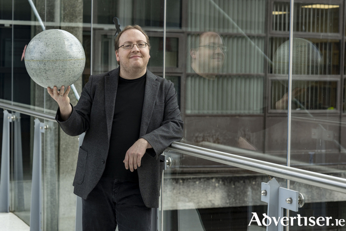 Dr Christian Ginski at University of Galway holding a scale model of the moon. Credit: Andrew Downes/Xposure 