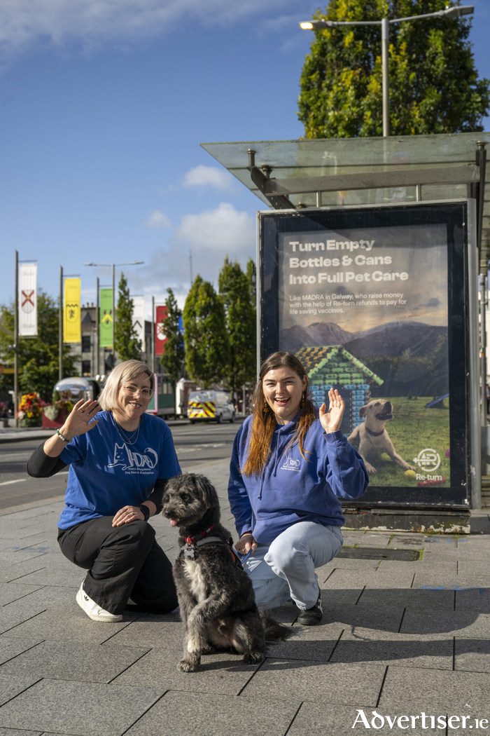 Saoirse Holic and Louise O’Toole from MADRA with Lenny, a Madra rescue dog, celebrating their Small Town, Big Difference win in front of their local 
advertisement. 
Photo: Andrew Downes, 
xposure.