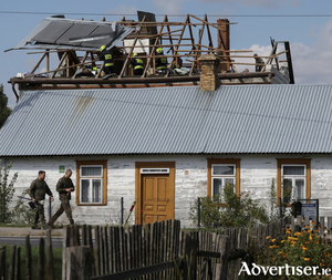 Polish soldiers walk below as firefighters work on the destroyed roof of a house, after Russian drones violated Polish airspace during an attack on Ukraine, with some being shot down by Poland with the backing from its Nato allies, in Wyryki, Lublin Voivodeship, Poland. 
Photograph: Kacper Pempel/Reuters