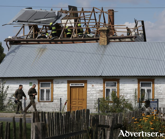 Polish soldiers walk below as firefighters work on the destroyed roof of a house, after Russian drones violated Polish airspace during an attack on Ukraine, with some being shot down by Poland with the backing from its Nato allies, in Wyryki, Lublin Voivodeship, Poland. Photograph: Kacper Pempel/Reuters