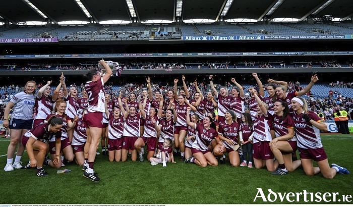 The Galway team, including Aoife Donohue, 12, celebrate with the O'Duffy Cup after the Glen Dimplex All-Ireland Senior Camogie Championship final match between Cork and Galway at Croke Park in Dublin. (Photo by Ramsey Cardy/Sportsfile)