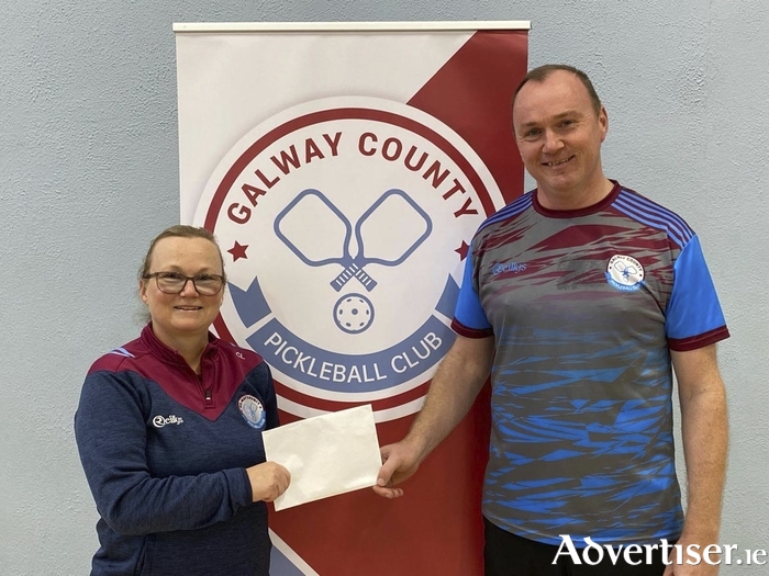 On behalf of Galway County Pickleball Club, Chairperson Caitriona Lawless presents sponsorship to Frank Kirrane in support of his participation at the European Pickleball Championships in Rome.