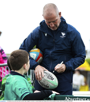 Head coach Stuart 
Lancaster signs a 
supporter&#039;s ball after a Connacht Rugby open training session at 
Dexcom Stadium in 
Galway. 
(Photo by Thomas Flinkow/Sportsfile)