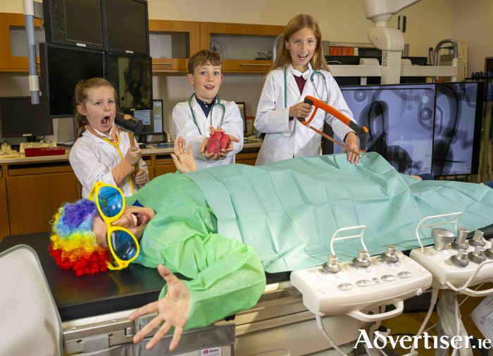 Young wannabe surgeons Chloe Sheeran, Daniel Craughwell and Eva O’Connell “operate” on Professor Bobaide in the Hybrid Lab at Medtronic during the launch of the 28th Galway Science & Technology Festival. Photo: Andrew Downes, xposure.