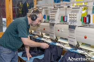 Pictured is Albert Cottle, who has embroidered the complimentary beanies that are being given to customers for Black Friday.&nbsp;