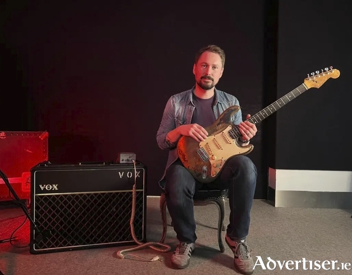 David Hawkins holding Rory Gallagher's guitar