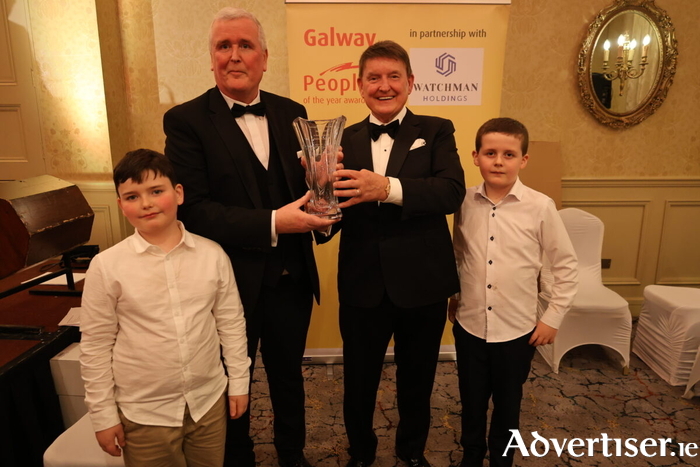 Galway Person of the Year award winner Donal Lynch with his grandsons Caolin and Evan, being presented with his award by Basil Holian