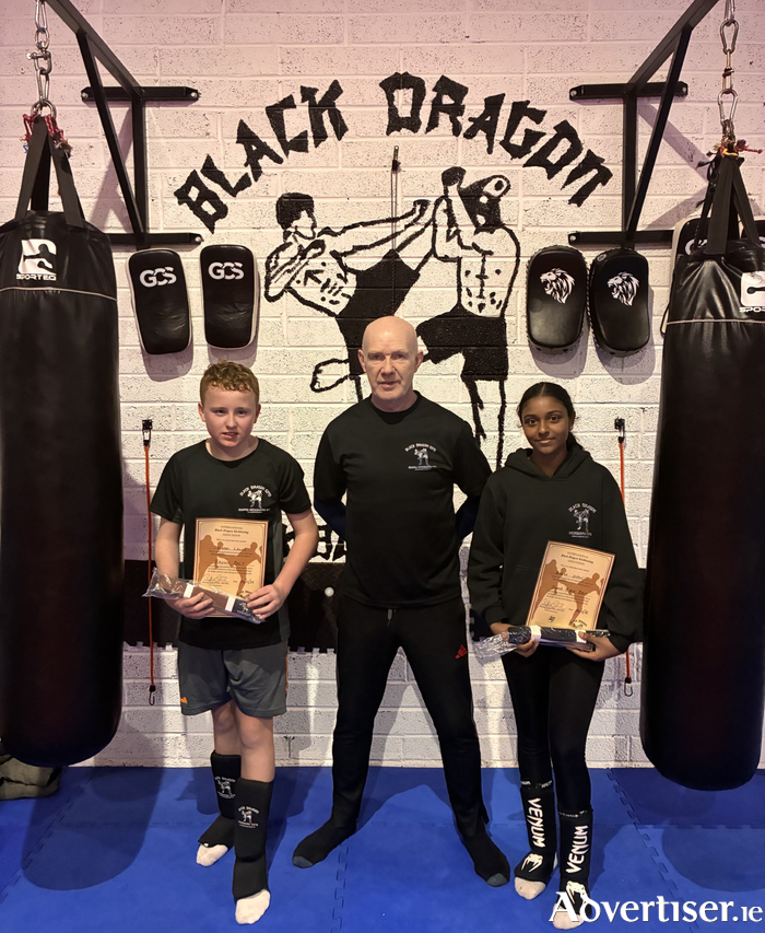 Galway Kickboxers Michael Lally (13) and Ameya Dipin (12) both pictured with their coach Pete Foley from Annaghdown.