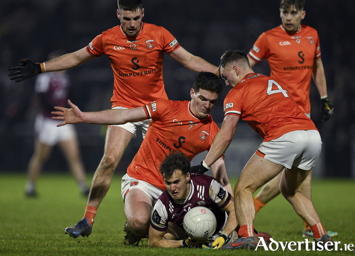 Rob Finnerty is tackled by Peter McGrane, 4, and Jarly &Oacute;g Burns of Armagh